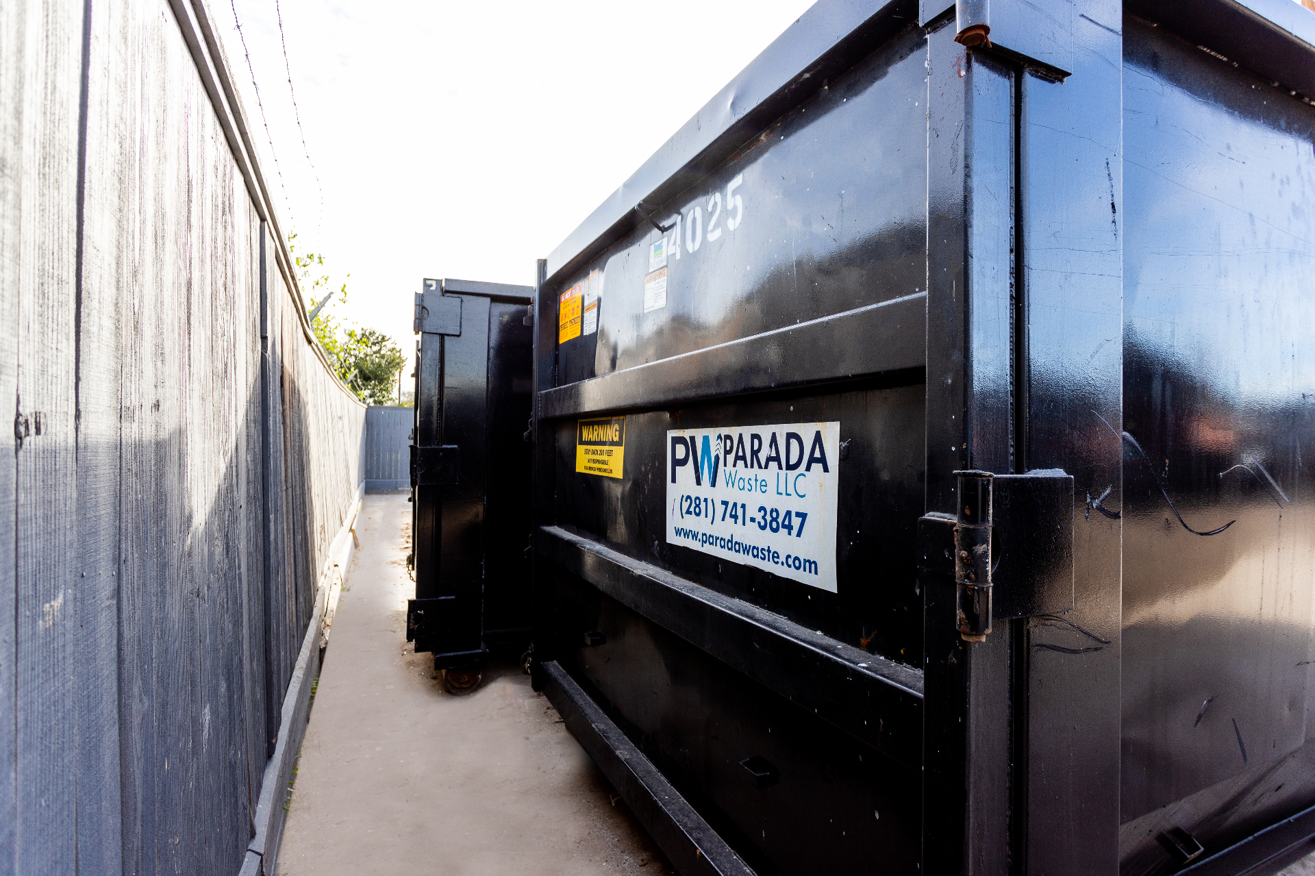 Parada Waste branded dumpster on site